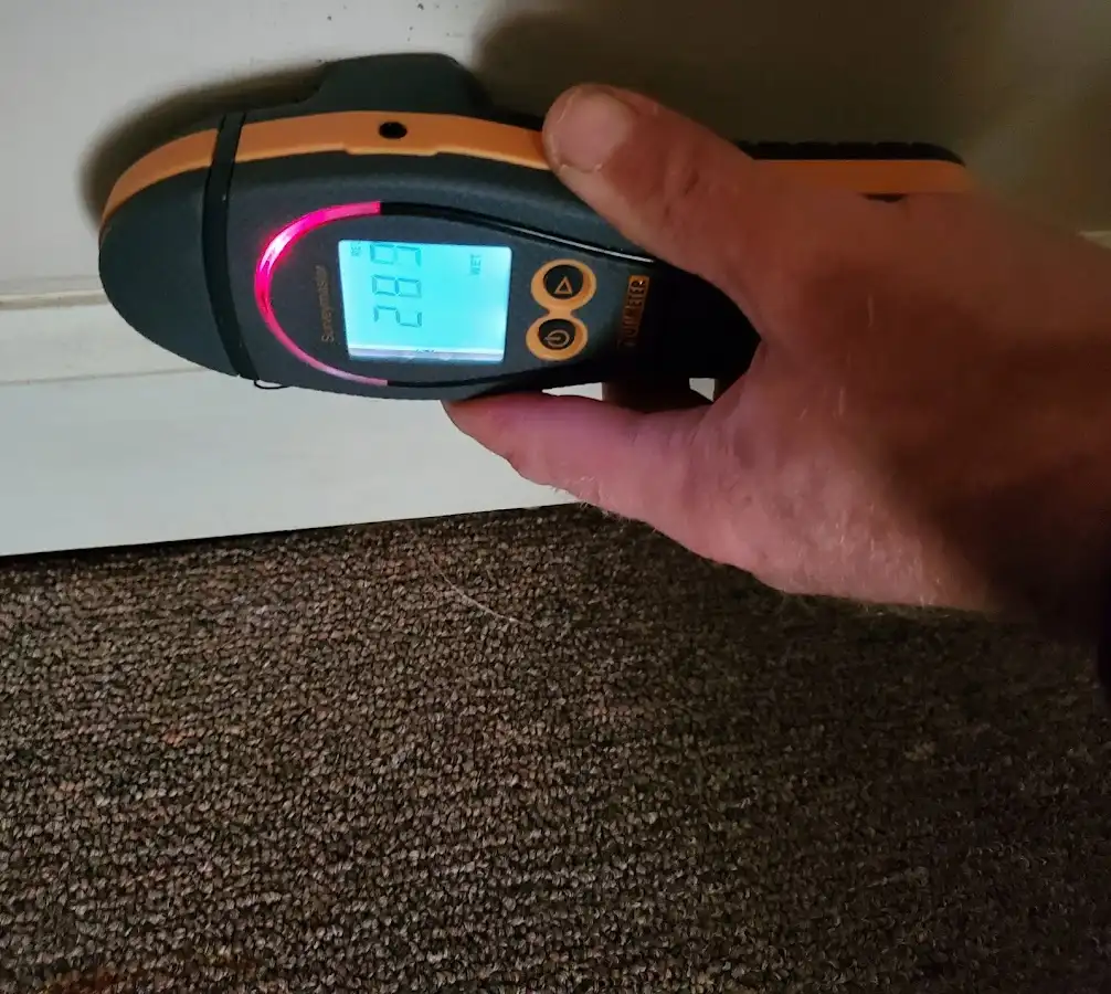 Moisture detection at baseboard during Storm Damage Restoration in Walker